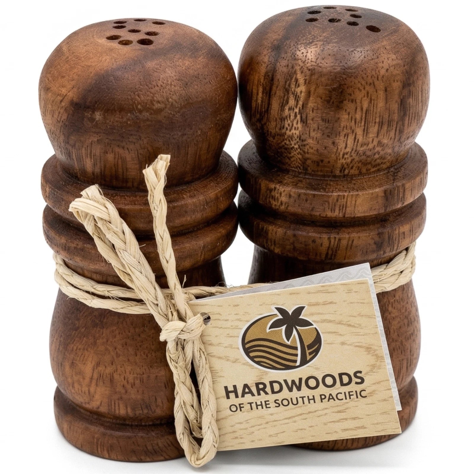 Wooden salt and pepper shakers with a Hardwoods of the South Pacific tag on a white background