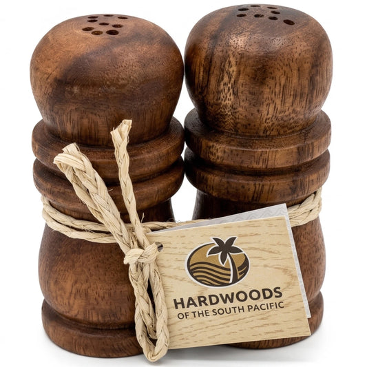 Wooden salt and pepper shakers with a Hardwoods of the South Pacific tag on a white background