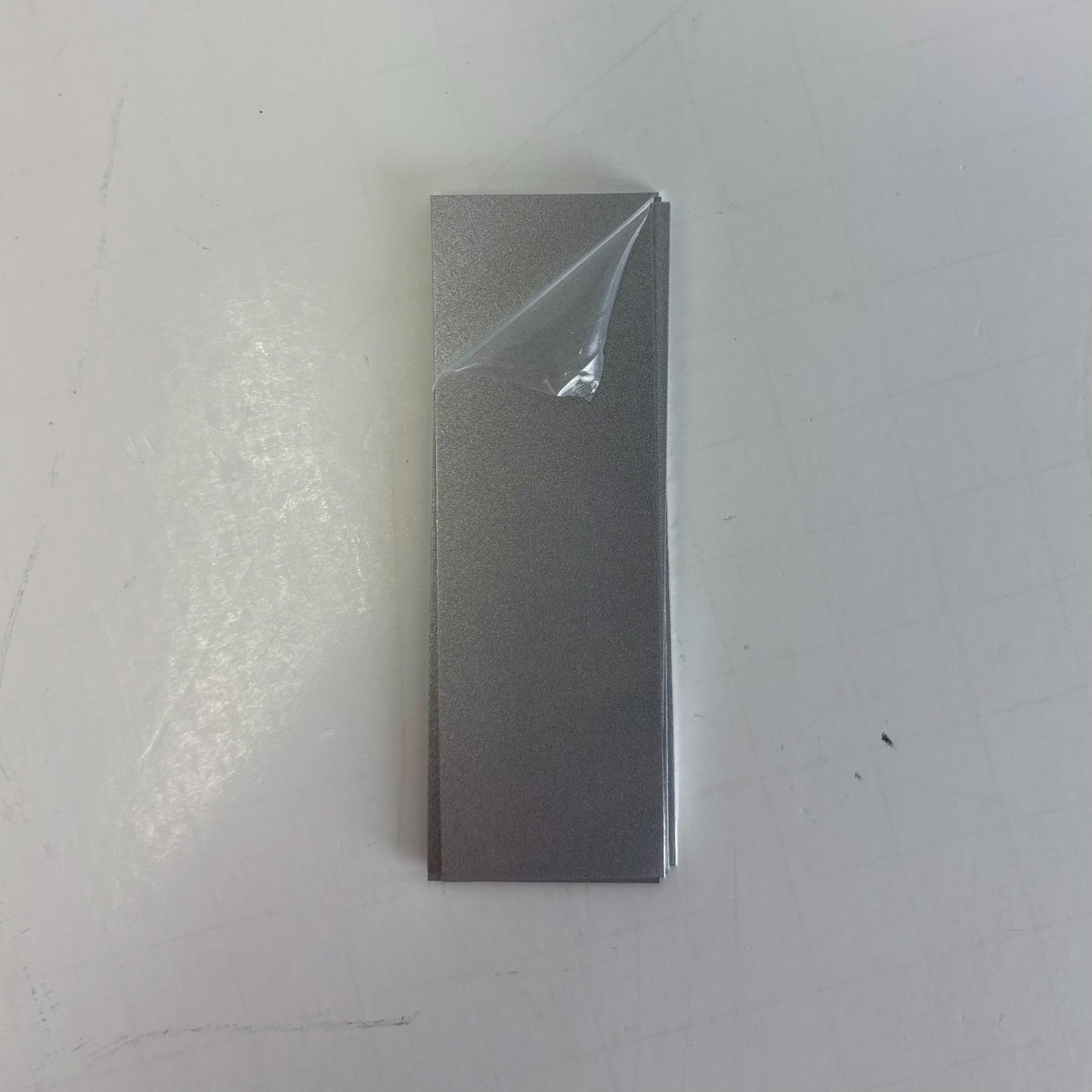 custom sized metal sheets with protective plastic. silver engraves black