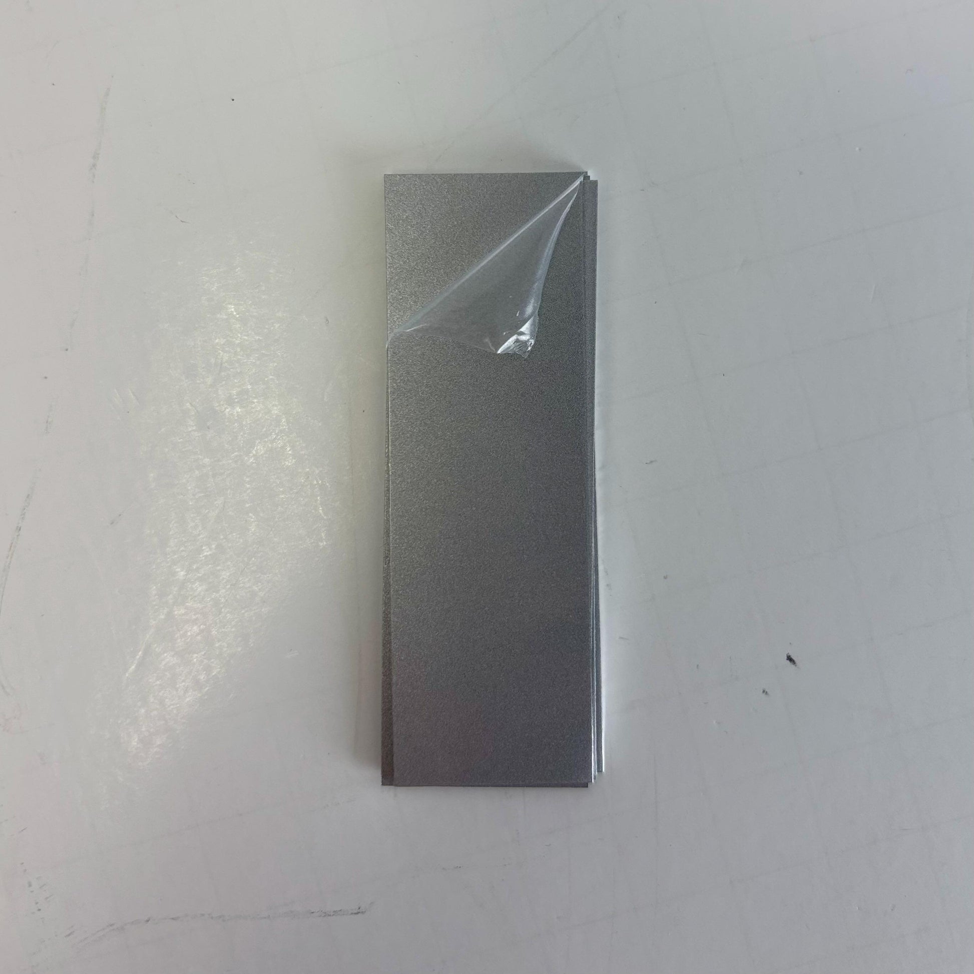 custom sized metal sheets with protective plastic. silver engraves black