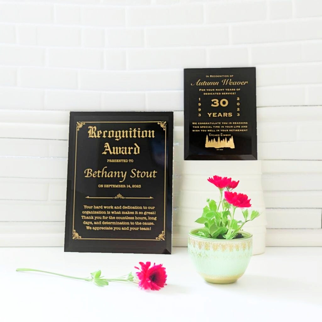 Black glass award plaque with gold writing